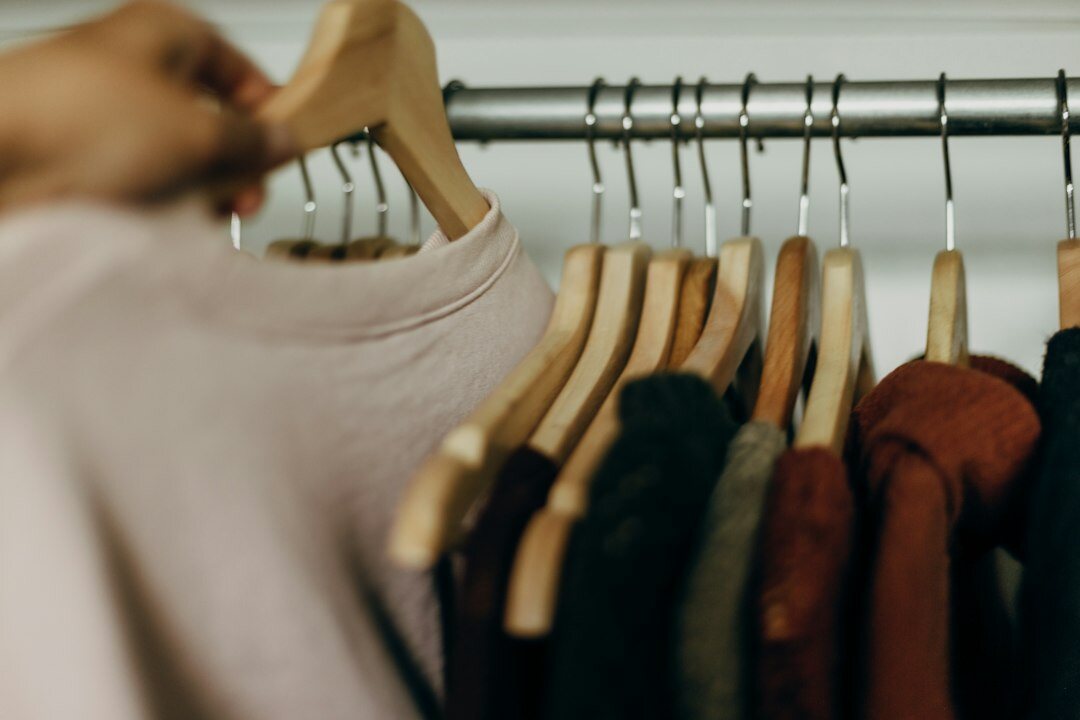 woman organizing clothes in closet