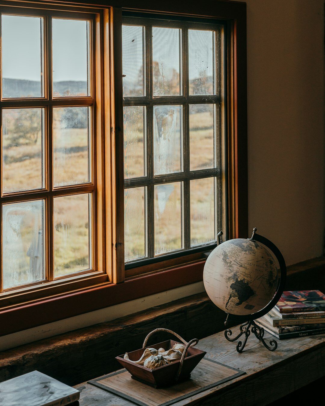 Notebook and cup of mate on a home desk near a window