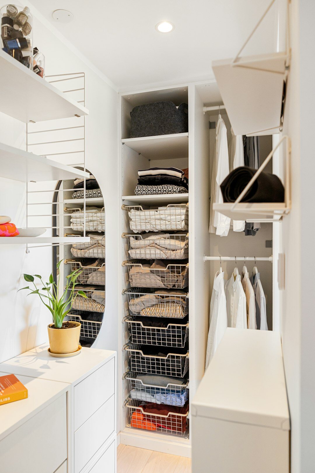 Organized closet with folded clothes and labeled boxes