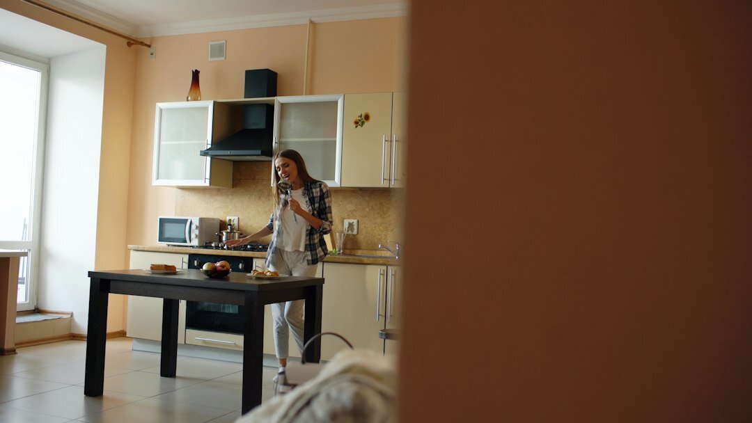 person cleaning kitchen