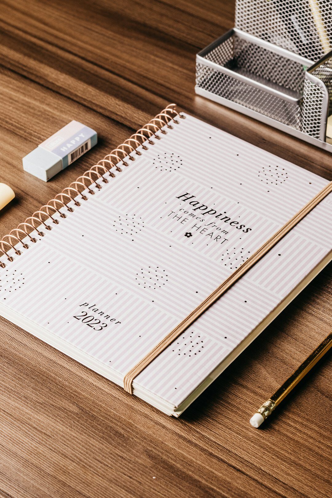 Household checklist notebook on a wooden table with a pen